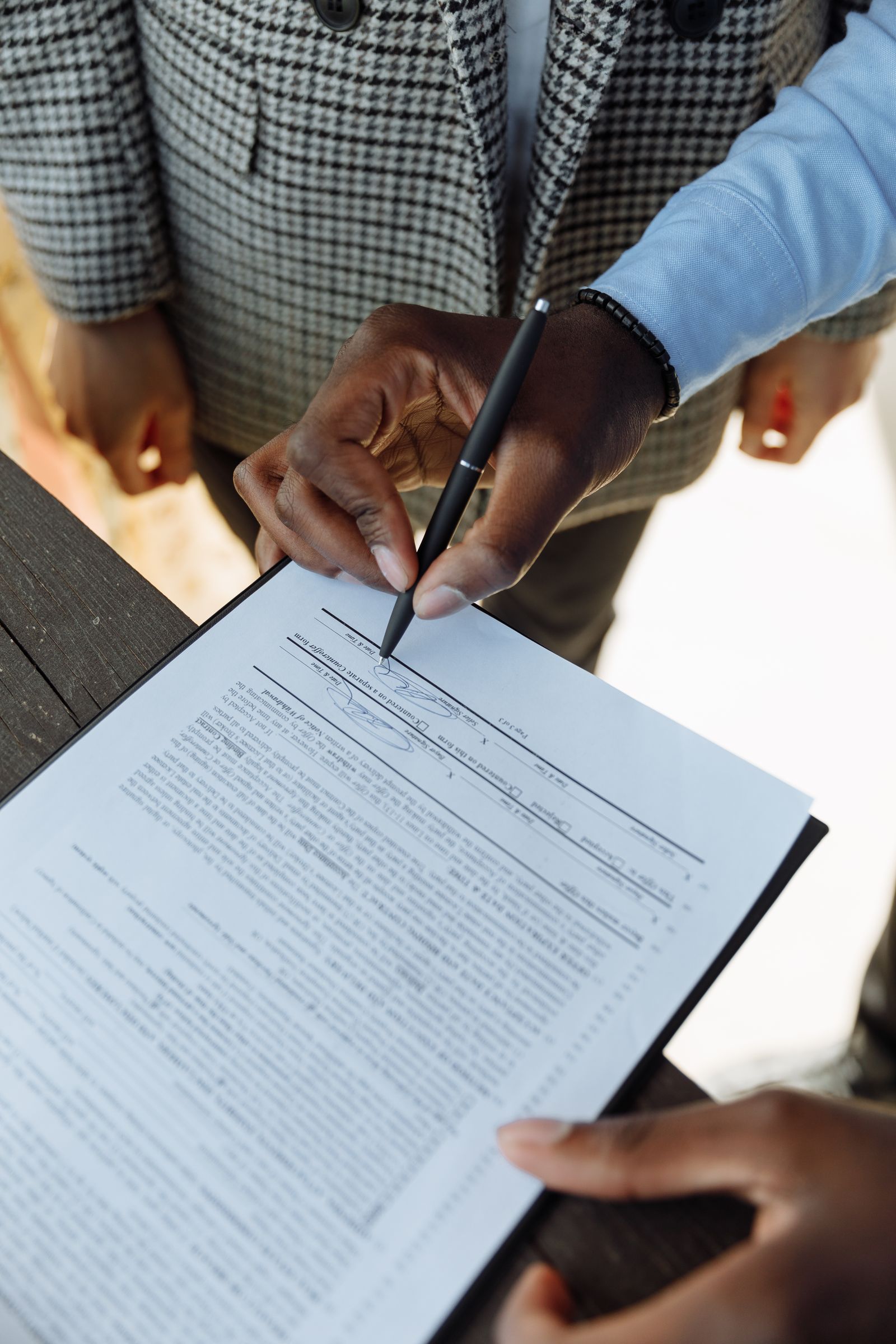 Signing divorce papers with a McKinney divorce lawyer